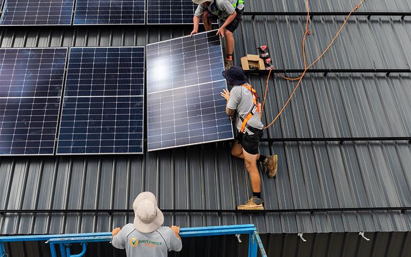 roof commercial solar panel installers at work