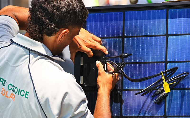 man installing solar batteries